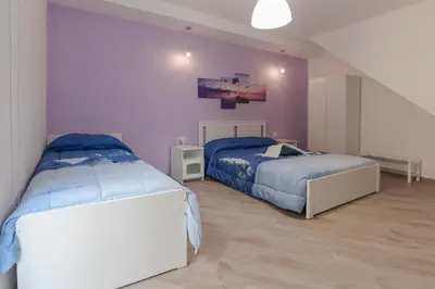 Letto o letti in una camera di Casa Rossini