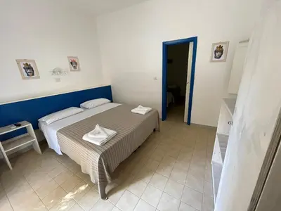 Letto o letti in una camera di Villaggio Turistico Europeo