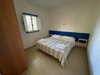 Letto o letti in una camera di Villaggio Turistico Europeo