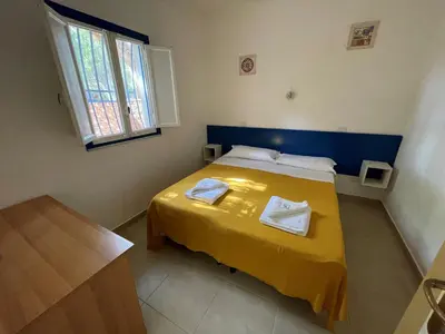 Letto o letti in una camera di Villaggio Turistico Europeo