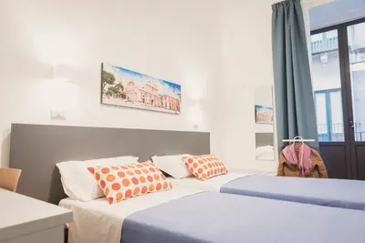 Letto o letti in una camera di Fladi House Catania