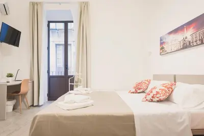 Letto o letti in una camera di Fladi House Catania