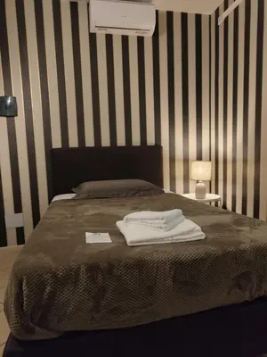 Letto o letti in una camera di Hotel Trieste