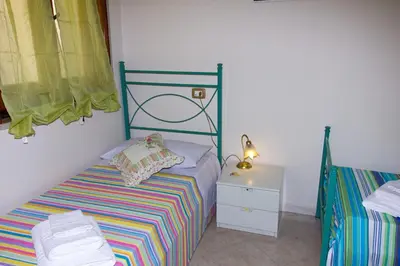 Letto o letti in una camera di Casa Caramella