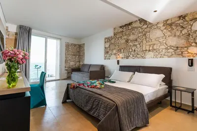 Letto o letti in una camera di Re Dionisio Luxury Suites