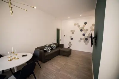 Area soggiorno di Green House - 1 Min dal Mare-Vicinissimo ad Ortigia e al Teatro-parcheggio fuori ZTL in strada gratuito