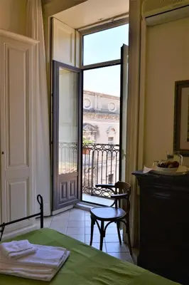 Letto o letti in una camera di Al Teatro Massimo Suites
