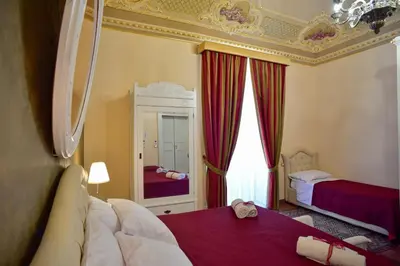 Letto o letti in una camera di Palazzo degli Affreschi