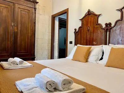 Letto o letti in una camera di Strelitzia's house with heated pool , private garden and private parking & wi-fi
