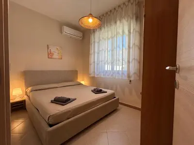 Letto o letti in una camera di Red house near the sandy beach, parking & wi-fi