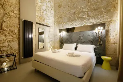 Letto o letti in una camera di ISONZO SUITES