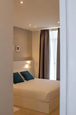 Letto o letti in una camera di Le Suite del Corso