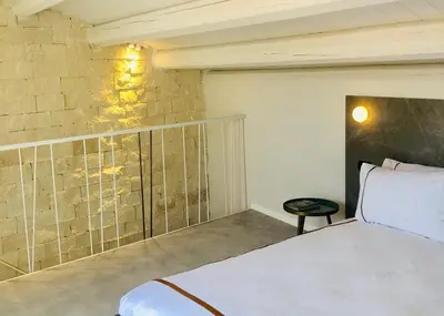 Letto o letti in una camera di Alma White Suite