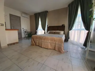 Letto o letti in una camera di B&B città del carrubo