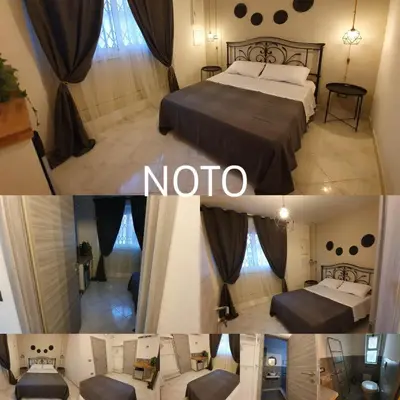 Letto o letti in una camera di B&B città del carrubo