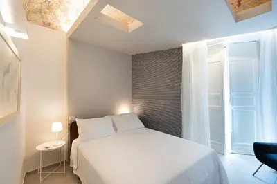 Letto o letti in una camera di Sant'Agostino Luxury Apartments