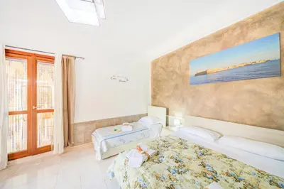 Letto o letti in una camera di B&B Sicilia Bella
