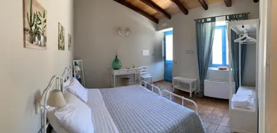 Letto o letti in una camera di Masseria Santacatrini