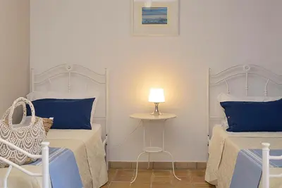 Letto o letti in una camera di Villa Giannina