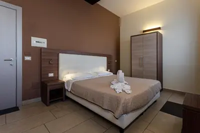 Letto o letti in una camera di Hotel Don Giovanni