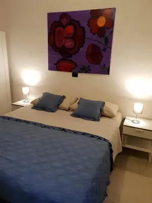 Letto o letti in una camera di Rooms in the Beach