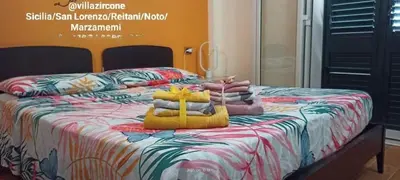 Letto o letti in una camera di Reitani San Lorenzo Marzamemi Noto VILLA ZIRCONE