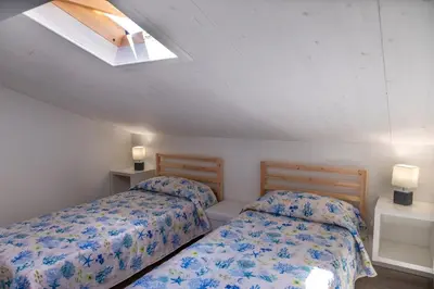 Letto o letti in una camera di VJMAN House Sea Beach - SiciliaVacanza