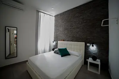 Letto o letti in una camera di Al Cortile del Re Luxury Home