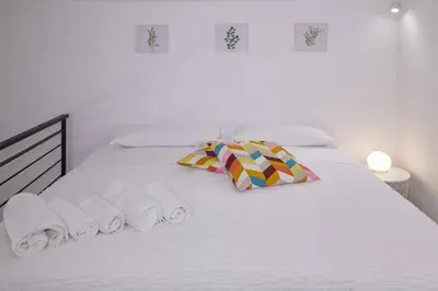 Letto o letti in una camera di La Palma Loft Located in the Heart of Catania
