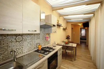 Cucina o angolo cottura di RE SOLE CASE VACANZE - Esclusivo Attico M A R T E con spaziosissima terrazza solarium attrezzata