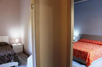 Letto o letti in una camera di RE SOLE La Dependance - Casa vacanza V E N E R E