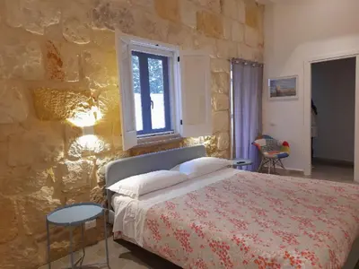 Letto o letti in una camera di Casa Maria ampio appartamento per famiglie vicino Ortigia