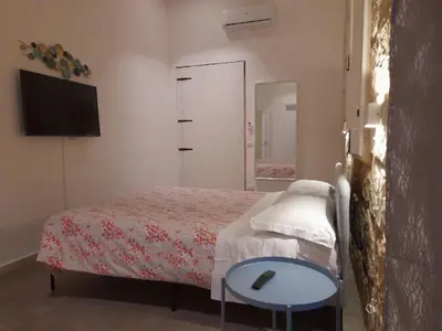 Letto o letti in una camera di Casa Maria ampio appartamento per famiglie vicino Ortigia