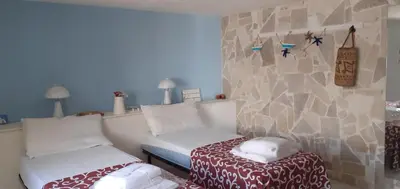 Letto o letti in una camera di san lorenzo a 4 mt dal mare colore smeraldo a due passi da Marzamemi
