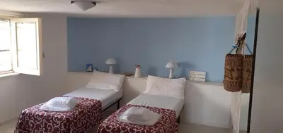 Letto o letti in una camera di san lorenzo a 4 mt dal mare colore smeraldo a due passi da Marzamemi