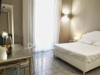 Letto o letti in una camera di Palazzo La Piana Rooms