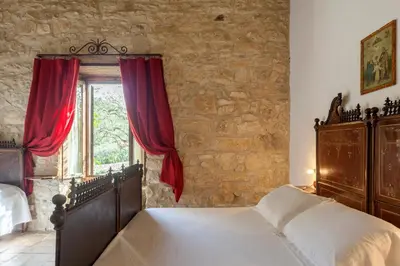 Letto o letti in una camera di Masseria Fortificata Lo Zafferaneto