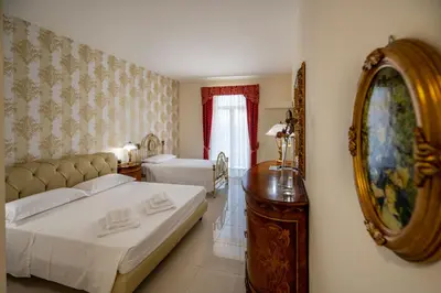 Letto o letti in una camera di Villa Floyd Charming Rooms B&B