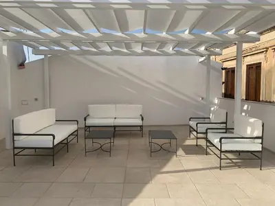 Area soggiorno di Amate Case by Ortigia Apartments