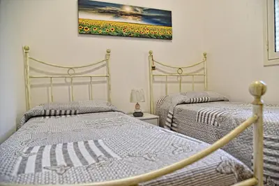 Letto o letti in una camera di La Gardenia