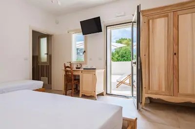 Letto o letti in una camera di Abbèntu B&B