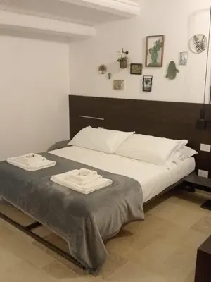 Letto o letti in una camera di IBLA ROOMS