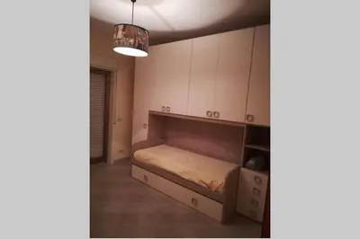 Letto o letti in una camera di Casa Helios con ascensore