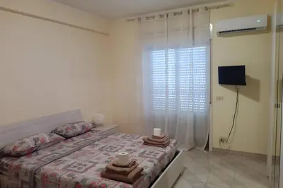 Letto o letti in una camera di Casa Helios con ascensore