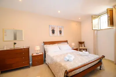 Letto o letti in una camera di Home Paola