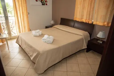 Letto o letti in una camera di VILLA LIBECCIO appartment with shared swimming pool, at 200 meters from the beach, solarium and private parking
