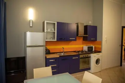 Cucina o angolo cottura di VILLA LIBECCIO appartment with shared swimming pool, at 200 meters from the beach, solarium and private parking