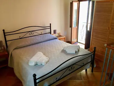 Letto o letti in una camera di La casa con il terrazzo,via arizzi Ortigia