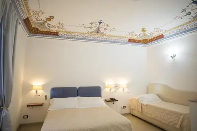 Letto o letti in una camera di Aretusa Vacanze B&B