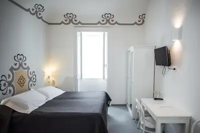 Letto o letti in una camera di Aretusa Vacanze B&B